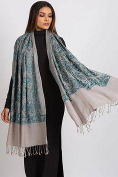 Our Surani Embroidered Shawl features fine embroidery on a soft blend of 80% wool and 20% polyester. This classically beautiful shawl showcases the intricate embroidery traditions of Northern India in stunning jewel tones on a silver base. Elegant Embroidered Pashmina Shawl For Festive Occasions, Elegant Embroidered Festive Pashmina Shawl, Elegant Winter Festive Pashmina Shawl, Elegant Festive Scarves With Embroidered Border, Elegant Embroidered Jamawar Pashmina Shawl, Elegant Embroidered Jamawar Scarves, Elegant Pashmina Shawl With Resham Embroidery, Elegant Shawl With Embroidered Border, Elegant Winter Dupatta Scarf