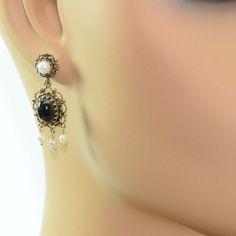 14K Yellow Gold Black Onyx and Pearl Drop Ear Pendants, 8x10mm high dome oval cabochons, 3 pearl drops with larger pearl on stud, 1 1/2 inch x 1/2 inch, baroque style, Circa 1960, 7.3 grams SKU # BB275E26 This listing contains photographs of the actual item you will receive. Our items are in excellent condition with little or no signs of wear and many are one of a kind pre-owned estate finds. Please look closely at the pictures in this listing as they are part of the product description. Please Gold Coin Ring, Coin Ring, Baroque Style, Baroque Fashion, Fine Jewelry Designers, Yellow Gold Earring, Blue Topaz Ring, Topaz Ring, Pearl Drop