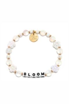 Embrace your personal growth and flourish with our "Bloom" bracelet from Little Words Project. This delicately crafted piece symbolizes new beginnings and the beauty of blooming where you are planted. Perfect for inspiring daily positivity and strength, it features elegant flower beads and a reminder to thrive in all aspects of life. Whether you're treating yourself or gifting a loved one, the "Bloom" bracelet is a chic reminder to keep growing and shining. Celebrate your journey with this beaut Inspirational White Bracelets For Friendship, Delicate White Bracelets For Spring, White Delicate Bracelet For Spring, Delicate White Bracelet For Spring, Meaningful White Jewelry With Letter Beads, Meaningful White Beaded Hypoallergenic Bracelets, Meaningful White Hypoallergenic Beaded Bracelets, Meaningful Hypoallergenic White Bracelets, Adjustable Letter Beads Jewelry For Spring