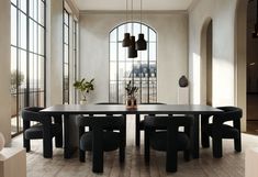 a dining room table with black chairs in front of large windows and potted plants