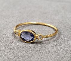 1. 18k Gold Blue Sapphire Ring 2. Made to Order 3. Gemstone - Blue Sapphire 4. Jewelry Type - Gold Ring 5. Total Weight - 1.030 Gram Approx 6. Sapphire Weight - 0.40 Carats 7. Diamond - 0.05 Carats 8. Gold Weight - 0.940 Grams Approx. 9. Sapphire Size - 4x6 MM 10. Gold Purity - 18k 11. Handmade Items 12. Band Size - 1 MM 13. Oval Blue Sapphire 14. AAA Quality 15. Stackable Ring 16. 1 Quantity Available Pictures are taken under natural and day light. Blue And Gold Rings, Oval Blue Sapphire Ring, Vintage Gold Sapphire Ring, Golden Sapphire Ring, Oval Gemstone Ring, Saphire Engament Ring Gold Band, Blue And Gold Ring, Sapphire Cabochon Ring, Creative Rings