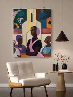 a white chair sitting in front of a painting on the wall next to a table