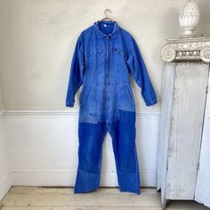 Hello and welcome to the Textile Trunk! Please follow us on Instagram, we are @textiletrunk  Absolutely unbelievable! This is a vintage French jumpsuit / pantsuit is just wonderful! Made of a classic blue denim, with patching, mends and just an overall timeworn fabulous look! this wonderful textile is vintage and I date it to somewhere around 1950-1970 ~ It has some fabulous wear Very heavy weight denim cotton ~ beautiful blue!  MEASUREMENTS : These wonderful overalls measure approximately Waist: 38 inch waist * with elastic back  Chest : 48 inches around  Hips are about 48 inches around  Length: 42 inches long from waist to ankle cuff  Inseam: 30 inches CONDITION :  Freshly laundered and ready to use! There are many fabulous mends There are large patches and there are holes in the pocket! Vintage Denim Blue Jumpsuit With Pockets, Vintage Medium Wash Denim Jumpsuit For Work, Vintage Fitted Denim Jumpsuit For Work, Fitted Vintage Denim Jumpsuit For Work, Vintage Fitted Blue Overalls, Retro Workwear Overalls, Vintage Blue Jumpsuits And Rompers For Workwear, Retro Blue Denim Jumpsuit With Pockets, Vintage Blue Fitted Overalls