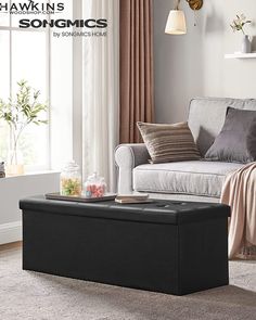 a living room scene with focus on the footstool and coffee table in the foreground