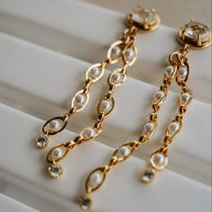 Our Pippa Drop Earrings are stunning + unique! What do we love about them? These gorgeous pearl chain earrings are so sophisticated and timeless. The perfect look for the minimalist bride or to elevate your everyday look with a little extra glam! You're sure to receive compliments any time you wear them! EARRING FEATURES 14k gold plated brass oval cubic zirconia posts Tiny yellow-gold CZ charm accent at the end of each pearl chain Yellow gold plated brass link chain with acrylic pearl accents Minimalist Bride, Chain Extenders, The Minimalist, Pearl Chain, How To Apply Makeup, Polish Jewelry, Gold Filled Jewelry, Chain Earrings, Cleaning Jewelry