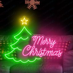 a christmas tree neon sign on a couch