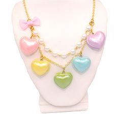 "A cute and sweet statement necklace for Valentine's Day or lovecore season! This kawaii charm necklace includes Five heart shaped macaron ( macaroon ) pendants in pastel shades with a pearly finish and whipped cream center. Each necklace includes five 1\" (2.5 cm) size charms hanging on a two-layered chain necklace with glass pearls on your choice of a 21\" gold plated or silver plated chain. Accented with a baby pink fabric ribbon bow on one side. Necklace will be finished with a Fatally Feminine Designs engraved heart charm. Closes with a lobster clasp. **Made to order - please allow 2 weeks for your item to be made before shipment** Matching Earrings and rings in my shop: https://etsy.com/shop/fatallyfeminine Every order comes with free gift packaging. Please contact me with any questi Multicolor Heart-shaped Kawaii Jewelry, Sweet Multicolor Heart-shaped Jewelry, Kawaii Multicolor Heart-shaped Jewelry, Kawaii Necklaces For Valentine's Day, Cute Multicolor Heart Shaped Necklace, Cute Multicolor Heart Necklace, Kawaii Style Necklaces For Valentine's Day Gift, Cute Multicolor Heart Charm Necklace, Kawaii Heart Beads Jewelry Gift