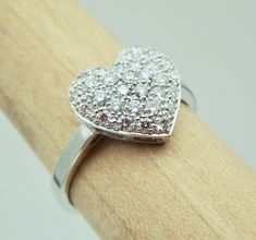 "This pave diamond heart shape ring is hand made in 18k white gold. The diamonds total weight is 1/2 carats The diamonds are VS clarity and G color range. We make all our own jewelry and focus on quality and durability. We can make it any size from 5-7 and you still be able to return it within the listed time frame. Sizing outside of that range requires a resize fee if for any reason the ring is retuned. Ring sizing may add additional handling time. We love this ring because it represents the wa Hallmarked Heart-shaped Diamond Ring, Diamond Heart Ring Hallmarked, Valentine's Day Diamond Heart Ring, Hallmarked, Valentine's Day Diamond Heart Ring Hallmarked, Valentine's Day Hallmarked Diamond Heart Ring, Diamond Heart Cut Ring Hallmarked, Hallmarked Heart-shaped Diamond Ring For Anniversary, Wedding Heart Ring With Hallmarked Diamond, Fine Jewelry Hallmarked Heart Cut Heart Ring