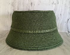 Crocheted green raffia hat It is a classic accessory for sun protection, summer parties, beach and travel. The hat is crocheted from natural raffia, light, elastic, small fields of the hat are reinforced with wire. The hat keeps its shape well and does not fade in the sun. The cap is soft to the touch, slightly rough. It is fully crocheted. Easy to carry with foldable design. The hat is perfect for summer wardrobe. Field Size: about 2,4 inches (6 cm) Care of the product:        It is better to dry the hat naturally, without using additional heating sources. When the raffia product dries, it returns to its original shape.        You cannot wash them in the usual way. If it gets dirty, clean it with soapy water and a sponge. The surface is gently wiped and left to dry in the shade. Items sho Handwoven Bucket Hat For Spring Vacation, Spring Vacation Handwoven Bucket Hat, Casual Handwoven Crochet Hat For Spring, Flat Brim Crochet Hat For Beach Season, Flat Brim Crochet Hat For The Beach, Summer Crochet Woven Bucket Hat, Crochet Fedora Hat For Vacation, Lightweight Toquilla Straw Crochet Hat For Summer, Handwoven Summer Bucket Hat For Spring