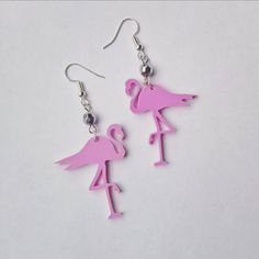 Pink Flamingo acrylic earrings A quirly kitsch style pair of earrings with a pink acrylic 3 cm Flamingos Hung from either a silver plated or sterling silver earring hook. Finished with a silver bead. Drop length: 1.5 inches All components are allergy and nickel free. Hand made in Britain. Quirky Handmade Pink Earrings, Quirky Pink Jewelry Gift, Quirky Pink Jewelry As A Gift, Fun Pink Dangle Jewelry, Pink Fun Dangle Jewelry, Pink Novelty Dangle Jewelry, Whimsical Pink Nickel-free Earrings, Whimsical Nickel-free Pink Earrings, Quirky Pink Earrings