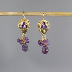 "Amethyst protection earrings and necklace set feature an organic piece of gold filled shaped like a knight shield set with natural amethyst. This jewelry set has a strong spiritual meaning and is meant to protect its wearer. This unique and original amethyst jewelry set will add a wonderful touch of elegance to that special outfit. Earrings measurements: Width: approx. 1.3 cm Length: approx. 4 cm with hook Earrings materials: Stone: amethyst Metal: gold filled Necklace measurements: Necklace le Purple Teardrop Amethyst Ring, Lavender Amethyst Earrings With Gemstone Accents, Purple Amethyst Earrings With Gemstone Accents, Amethyst Protection, Amethyst Jewelry Set, Purple Amethyst Earrings, Amethyst Properties, Knight Shield, Necklace Measurements