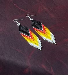 Black, multi-colored fringe style earrings. Dangle. 4 inch drop length. Brick stitch. Multicolor Long Drop Earrings With Beaded Fringe, Black Fringe Beaded Earrings, Multicolor Long Drop Beaded Earrings With Fringe, Beaded Sunset Earrings, Gradient Beaded Earrings, Multicolor Long Drop Fringe Earrings, Fire Color Beaded Earrings, Raven Seed Bead Earrings, Fringe Fashion