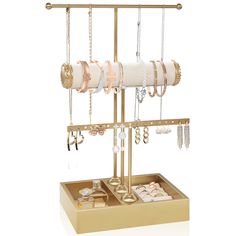 a gold jewelry stand with bracelets, earrings and rings hanging from it's sides