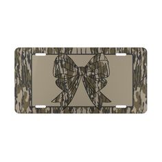 a camo license plate with a bow on the front and back of it's frame