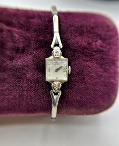 "This is a beautiful and dainty vintage Croton 10K White Gold Ladies Watch with 2 Tiny Diamond Accents. The stretch expandable band is by Kreisler 1/20 of 10K gold filled top. This is a mechanical watch, does not use batteries. It is not working and needs repair. Watch measures 1/2\" wide, Band is 6\" and expandable. Weighs 12.77 grams." Dainty Watches, Aesthetic Watches, Linda Smith, Silver Watches Women, Vintage Watches Women, Luxury Watch Brands, Brand Clothes, Watches Women, Magical Jewelry