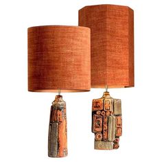 two lamps with different designs on them, one is orange and the other is brown