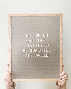 a person holding up a sign that says god doesn't call the quailified he