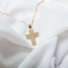 14K Solid Gold Christian Cross Pendant, with polished surface. A classic piece of jewelry ideal for a gift or baptism. All jewelry is made from 14 carat gold (14K) designed with particular craftsmanship. Match our jewelry with your personality and stand-out from the rest. Our world of jewels, your world of happiness! Baptism is called one of the seven ritual sacraments of the Christian churches using water as a symbol of purification, marking the introduction of the believer into the body of the Classic Crucifix Jewelry For First Communion, Silver Classic Jewelry For Baptism, Classic Cross Jewelry For Baptism, Classic Silver Jewelry For Baptism, Classic White Gold Cross Necklace For Anniversary, White Gold Polished Cross Necklace Gift, Classic White Gold Cross Necklace For Gift, White Gold Cross Necklace With Polished Finish As Gift, Classic 14k Gold Cross Necklace For Gift