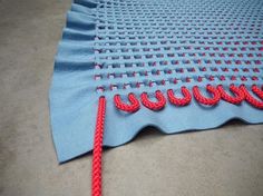 a piece of blue fabric with red thread on it