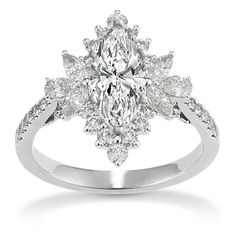 a white gold ring with an oval cut diamond in the center and leaves on each side