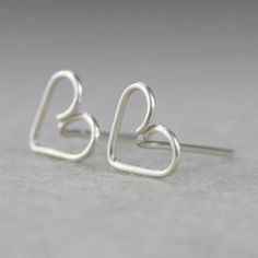 "This unique heart stud earrings are handmade wire wrapped sterling silver. Free US shipping Customers who purchased this item said: \"Very nice. Glad I bought them\" The heart is the ultimate symbol of love. This heart earrings are a perfect gift for the one you love, or for bridesmaid gift, or for birthday gift. We also can customize design for you. The dimension of the earrings is 9mm/3/8inches. ;-) My contact number: 626-379-1904. Please contact me if you would like to order multiples or cus Minimalist Earrings For Mother's Day Gift, Minimalist Sterling Silver Heart Earrings For Wedding, Silver Dainty Heart Earrings For Wedding, Sterling Silver Earrings For Anniversary, Minimalist Sterling Silver Earrings For Valentine's Day, Sterling Silver Earrings For Anniversary And Mother's Day, Sterling Silver Earrings For Mother's Day Anniversary, Wire Wrapped Earrings As Gift, Cute Silver Sterling Heart Earrings