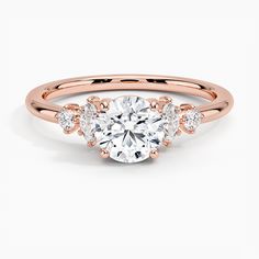 a rose gold engagement ring with three stones