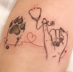 a tattoo with two hands and a dog's paw