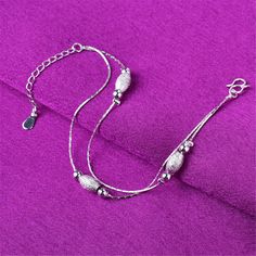 Show off your pedicure and add touch of light-catching shine to your ensemble with this elegant anklet plated in gleaming sterling silver. 0.31'' W x 9.84'' L S-hook clasp Fine silver-plated copper Elegant Anklet, Color Bracelets, S Hook, Hand Chain, Double Chain, Chain Anklet, Bracelets For Women, Colorful Bracelets, Ankle Bracelets