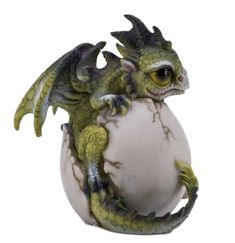 a dragon figurine sitting on top of a white ball