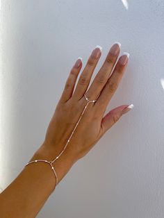 "Dainty 18k gold plated/platinum plated hand chain. Our hand chain is so flattering and comfortable to wear. Our chain is sparkly and sits so beautifully on the hand. Layer with some of your favourite rings and bracelets. We have always been obsessed with hand chains so we created our own. Hand chains are so dainty and give that extra sparkle and shine to your hands. Measurements:  Bracelet - 6.5-7\" inches (comes with extra adjustable 2\" chain extender) Wrist to finger - 7 cm Please feel free to send us over your measurements and we will make it a perfect fit for you! Message us or leave a note on your order with your measurements ♡ -  PROCESSING TIME -  This piece is handmade to order and is ready to ship in 1-2 business days.  - ABOUT MINKKSI -  https://www.etsy.com/shop/MINKKSI/about Permanent Hand Chain, Silver Chain Link Jewelry For Wedding, Adjustable Tarnish-resistant White Gold Chain Bracelet, Adjustable Silver Chain Jewelry For Wedding, Elegant White Silver Chain Bracelet, Dainty Adjustable White Gold Chain Bracelet, Adjustable White Gold Dainty Chain Bracelet, Delicate Silver Adjustable Chain Bracelet, Silver Delicate Adjustable Chain Bracelet