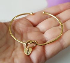 Personalized Bracelet, Gold Plated, Bangle Bracelet, Initial Heart, Engraved Heart, Bridesmaid Gift, Wedding Party, Initial Bracelet, Bangle Gorgeous gold plated bangle bracelet. It measures 54x62mm inner diameter. From the knot, it hangs a gold plated heart that can be engraved with an initial. Mix and match with other bracelets available in our store, for an effortlessly chic look! Also a perfect gift for your bff, your bridesmaids, or a special person in your life. Important! We are located i Elegant Adjustable Heart Bracelet For Best Friend, Adjustable Heart-shaped Charm Bracelet For Wedding, Adjustable Heart-shaped Wedding Charm Bracelet, Adjustable Heart Bracelet For Wedding And Mother's Day, Gold Bracelets For Bridesmaid Gift On Valentine's Day, Gold Bracelets For Bridesmaids, Valentine's Day Gift, Gold Bracelets For Bridesmaid Gift, Adjustable Heart Bracelet For Bridesmaid, Valentine's Day Gift, Wedding Bracelet With Heart Charm