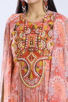 Peach asymmetric cape with floral pattern. Paired with a thread and tassel embroidered short inner kurta and sharara. - Aza Fashions Bohemian Sharara With Intricate Embroidery For Party, Bohemian Embroidered Sharara For Parties, Bohemian Party Sharara With Intricate Embroidery, Bohemian Anarkali Set With Resham Embroidery For Party, Bohemian Gota Work Dupatta For Designer Wear, Bohemian Gota Work Choli For Reception, Bohemian Designer Dupatta With Gota Work, Bohemian Anarkali Set For Designer Wear, Bohemian Palazzo Set With Dupatta For Parties