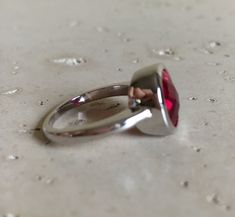 "A Classic oval shaped Faceted Lab Created Ruby Sterling Silver Ring featuring a comfort fit band with a bezel around the stone. This makes a great birthstone ring for those July Birthdays! Wrapped in a box ready for gift giving.(r-537) RING INFO ---------------- STERLING SILVER Stone with Bezel measure 11.5mm x 10mm July BIRTHSTONE *Follow us @belesasjewelry on Instagram for promotions/giveaways *LIKE* us on Facebook http://www.facebook.com/Belesas *If you like the ring, please click on the \"P Adjustable Red Oval Ruby Ring, Adjustable Oval Red Ruby Ring, Red Round Ring For Everyday, Everyday Red Round Ring, Red Bezel-set Round Band Rings, Red Ruby Ring With Bezel Setting, Red Oval Ring With Bezel Setting, Red Oval Rings With Bezel Setting, Red Oval Stackable Promise Rings