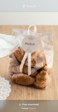 a bag full of croissants sitting on top of a wooden table