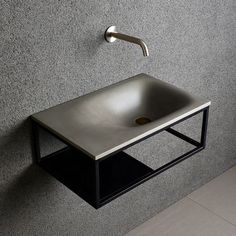 a sink mounted to the side of a wall