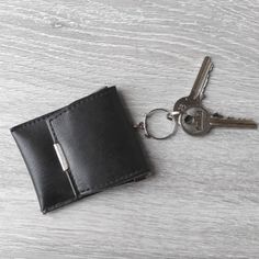 This vintage black mini keychain leather is the perfect accessory for anyone looking to keep their keys and coins organized. It doubles as a coin purse keychain and key holder, making it a practical and stylish option. The coin wallet keychain is an elegant unisex accessoryt. Its minimalist design makes it easy to carry and the perfect size for fitting in your pocket or bag. Stay organized and stylish with this versatile keychain wallet. top width 7 cm (2.75") height 8.5 cm (3.3") Thank you for Black Coin Purse With Key Clip For Travel, Black Travel Coin Purse With Key Clip, Black Rectangular Coin Purse With Key Clip, Black Keychain With Key Leash For Personal Use, Black Keychains With Interior Key Chain Holder, Black Keychain With Key Clip For Everyday Use, Coin Organizer, Wallet Keychain, Coin Purse Keychain