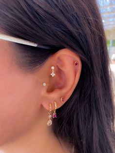 a close up of a person wearing some kind of ear piercing with other items in the background