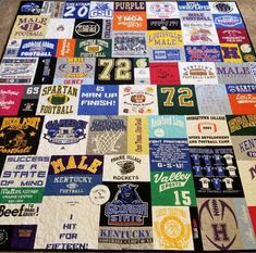 a large blanket with many different sports logos on it, all in various colors and sizes