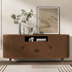 a wooden sideboard with two drawers and a vase on top