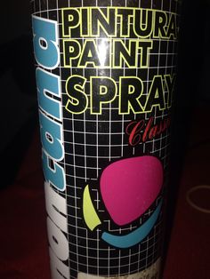 a can of pintura paint spray sitting on a red tableclothed surface with the words pintura painted on it