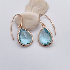 Elegant Aquamarine teardrop pendant Rose Gold earrings.  Earring  Measurements:  1" (drop length) Teardrop pendant: Aquamarine colored Glass Pendant (Rose Gold Plated) Pendant Measurements: Height - 17mm Width: - 12mm Ear Wires: Rose Gold Filled Ear Wires  All of my earrings come packaged with silicone backs to help prevent accidental loss, an earring card with my brand logo, and all of it is packaged in a beautifully colored organza bag.  If you would like to see more jewelry selections, please Teardrop Aquamarine Jewelry For Formal Occasions, Aquamarine Teardrop Jewelry For Formal Occasions, Teardrop Drop Earrings For Bridesmaids, Teardrop Earrings For Bridesmaid Gift, Gold Aquamarine Teardrop Jewelry, Luxury Aquamarine Teardrop Jewelry, Elegant Teardrop Rose Quartz Earrings, Aquamarine Colour, Earrings Rose Gold