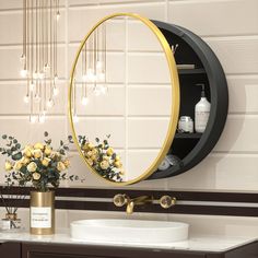 a bathroom with a sink, mirror and flowers in the vase on the counter top