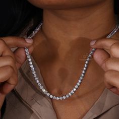 This Diamond Tennis Necklace is a beautiful statement piece made with 4.0 MM Round Lab Grown Diamonds on a Tennis Chain. Show your unique style with this eye-catching and elegant diamond necklace. "𝐓𝐨𝐠𝐞𝐭𝐡𝐞𝐫 𝐰𝐞 𝐜𝐚𝐧 𝐦𝐚𝐤𝐞 𝐭𝐡𝐞 𝐰𝐨𝐫𝐥𝐝 𝐚 𝐛𝐞𝐭𝐭𝐞𝐫 𝐩𝐥𝐚𝐜𝐞 𝐟𝐨𝐫 𝐥𝐢𝐯𝐢𝐧𝐠, 𝐥𝐞𝐭’𝐬 𝐠𝐨 𝐰𝐢𝐭𝐡 𝐦𝐢𝐧𝐢𝐧𝐠-𝐟𝐫𝐞𝐞 𝐝𝐢𝐚𝐦𝐨𝐧𝐝𝐬 𝐚𝐧𝐝 𝐡𝐚𝐧𝐝 𝐨𝐯𝐞𝐫 𝐚 𝐛𝐞𝐭𝐭𝐞𝐫 𝐭𝐨𝐦𝐨𝐫𝐫𝐨𝐰 𝐚𝐧𝐝 𝐜𝐥𝐞𝐚𝐧 𝐞𝐚𝐫𝐭𝐡 𝐭𝐨 𝐭𝐡𝐞 𝐜𝐨𝐦𝐢𝐧𝐠 𝐠𝐞𝐧𝐞𝐫𝐚𝐭𝐢𝐨𝐧𝐬. Dazzling Silver Single Strand Jewelry, Anniversary Diamond Cut Cubic Zirconia Chain Necklace, Dazzling Single Strand Round Cut Jewelry, Exquisite Diamond Cut Necklace In Diamond White, Luxury Chain Necklace For Weddings, Luxury Moissanite Tennis Necklace Gift, Silver Diamond Single Strand Jewelry, White Gold Diamond Single Strand Jewelry, Diamond White Cubic Zirconia Chain Necklace For Anniversary