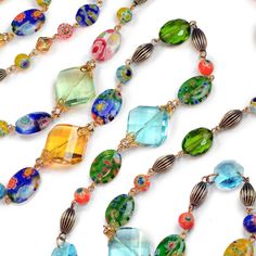 "For this necklace, colorful millefiori glass beads are blended with faceted crystal prisms in olivine green, sun yellow and aqua blue. Grooved metal beads are finished in warm bronze, providing a rich background for the color drenched beads. Millefiori means 'thousand flowers.' Bundles of tiny glass filament rods are sliced, then fired to meld their brilliant colors and floral patterns. No two beads are ever identical. Wear long or doubled. From our Candy Glass Collection. Style N586. Size: 48\ Prism Necklace, Jewelry Long Necklace, Groove Metal, Sun Yellow, Locket Bracelet, Necklace Colorful, Crystal Prisms, Jewelry Crystal, Glass Candy