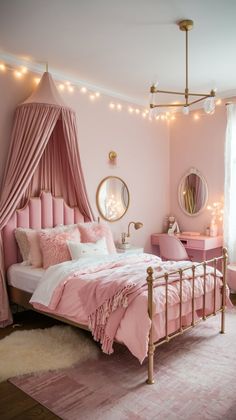 a pink and gold bedroom with lights strung from the ceiling, bedding, pillows, rugs, and curtains