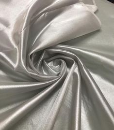 the fabric is shiny silver and it looks like it could be used as a dress