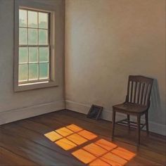 an empty room with a chair, window and light coming in from the windowsill