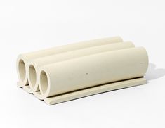 three white tubes are stacked on top of each other in order to form the shape of a tube