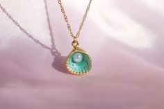 🌊 🐚 In the heart of an underwater kingdom, a green oyster pendant with a shimmering pearl was discovered. This necklace brings a touch of ocean magic and mermaid charm to your everyday style. ✨ 🎁 Your order will arrive in a pre-packaged special and cute box. Ready to be gifted to yourself or someone you care about! 🔍 DETAIL * Material: High quality of Gold Plated Brass * Chain Length: 40 +5 cm / 15.75 +1.95 inches (At the chain's end there is a + 5cm/1.9 inch extension) 📦 SHIPPING * Our pro Ocean-inspired Pearl Charm Jewelry As Gift, Ocean-inspired Pearl Charm Jewelry For Gifts, Ocean-inspired Pearl Charm Jewelry Gift, Ocean-inspired Pearl Pendant Jewelry, Green Pearl Drop Necklace Gift, Green Pearl Drop Necklace For Gift, Ocean-inspired Shell-shaped Jewelry Gift, Ocean-inspired Pearl Pendant Jewelry As Gift, Ocean-inspired Pearl Pendant Jewelry Gift