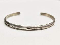 Crescent-shaped imprints decorate this sterling silver cuff bracelet from end to end, crafted by Navajo jewellery artist Douglas Etsitty. The bracelet is ovalish and fits snugly on the wrist.  Signed Douglas Etsitty, and hallmarked Sterling Inner diameter: 2¼ by 1¾ inches This cuff bracelet will be shipped via registered mail, at the airmail rate of the post office. Black And Silver Outfits, Silver Outfits, Navajo Jewelry, Sterling Silver Cuff Bracelet, Sterling Silver Cuff, Silver Cuff Bracelet, Outfits Women, Artistic Jewelry, Silver Cuff